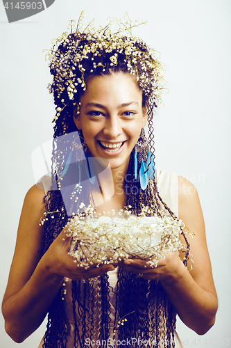 Image of pretty young woman with may-lily in hair and smoke in hands