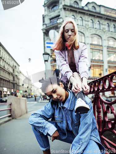 Image of cute young couple of teenagers girlfriends having fun, traveling europe, modern fashion citylife, lifestyle people concept