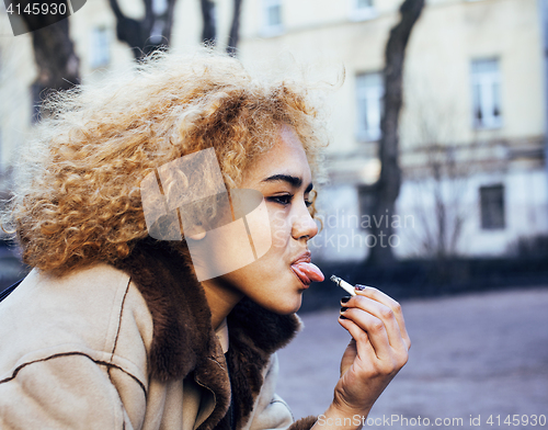 Image of young pretty girl teenage outside smoking cigarette, looking like real junky, social issues conceptyoung pretty girl teenage outside smoking cigarette, looking like real junky, social issues concept