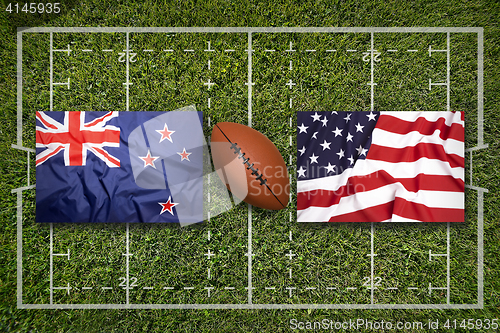 Image of New Zealand vs. USA flags on rugby field