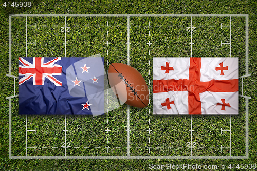 Image of New Zealand vs. Georgia flags on rugby field