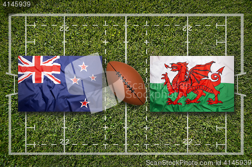 Image of New Zealand vs. Wales flags on rugby field