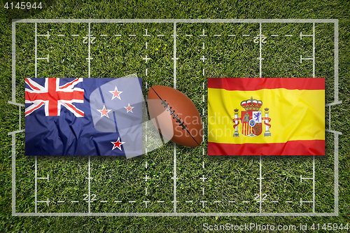 Image of New Zealand vs. Spain flags on rugby field