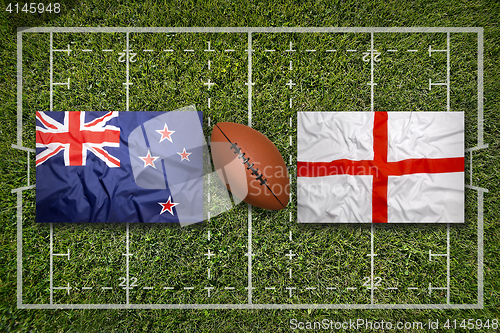 Image of New Zealand vs. England flags on rugby field
