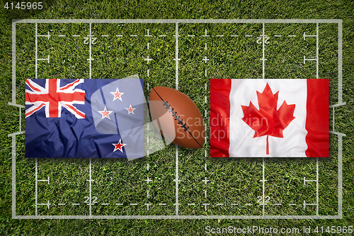 Image of New Zealand vs. Canada flags on rugby field