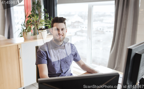 Image of happy creative male office worker with computer