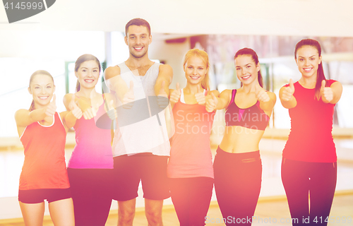 Image of group of people in the gym showing thumbs up