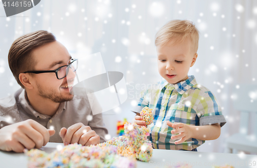 Image of father and son playing with ball clay at home