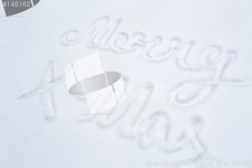 Image of merry christmas words on snow surface