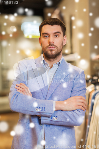 Image of young handsome man in jacket at clothing store