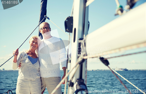 Image of senior couple hugging on sail boat or yacht in sea