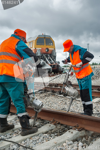Image of Railway workers repairing rail in Tobolsk. Russia