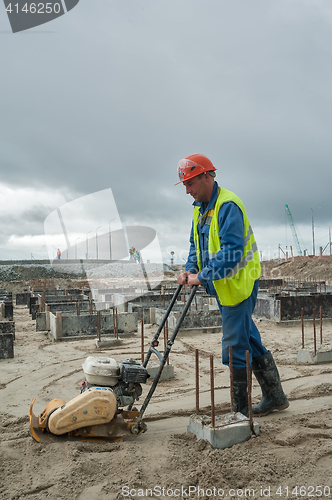 Image of Builder worker with vibration plate