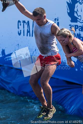 Image of Man with girl jump in water in extrim racing