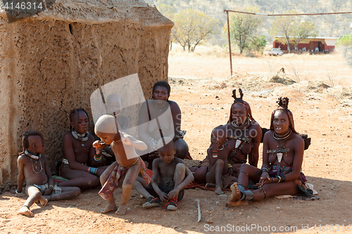 Image of Himba woman with child in the village