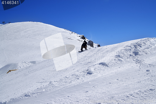 Image of Snowboarder in snow park at ski resort on sunny winter day