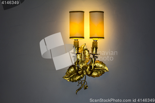 Image of Old wall lamp made of metal with shade from canvas