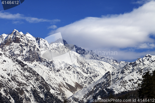 Image of Snow winter mountains and blue sky with clouds at sun day