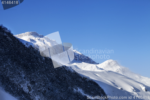 Image of Off-piste slope and sunlight blue sky in wind winter morning