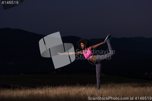 Image of black woman doing yoga  in the nature