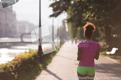 Image of Black woman doing warming up and stretching