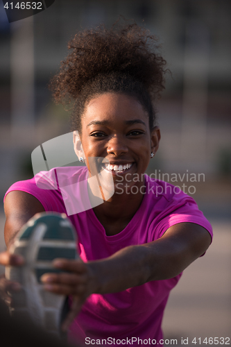 Image of African American woman doing warming up and stretching