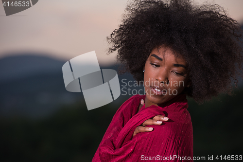 Image of outdoor portrait of a black woman with a scarf