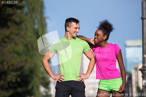 Image of portrait of young multietnic jogging couple ready to run