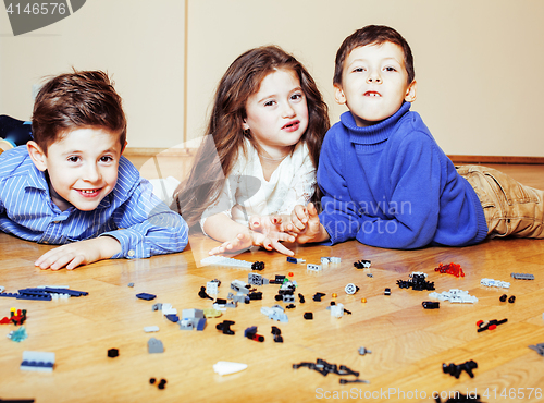 Image of funny cute children playing lego at home, boys and girl smiling, first education role lifestyle