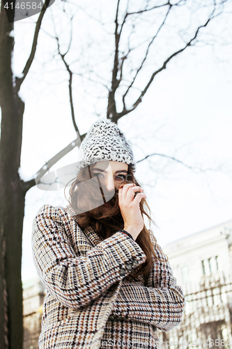 Image of young pretty stylish modern hipster girl outside on street, fash