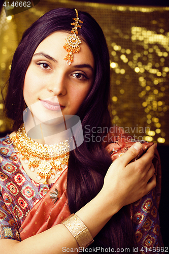 Image of beauty sweet real indian girl in sari smiling on black backgroun