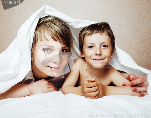 Image of young blond woman with little boy in bed, mother and son, happy familyyoung blond woman with little boy in bed, mother and son, happy family