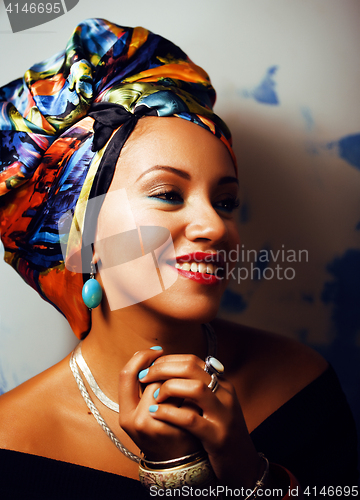 Image of beauty bright african woman with creative make up, shawl on head