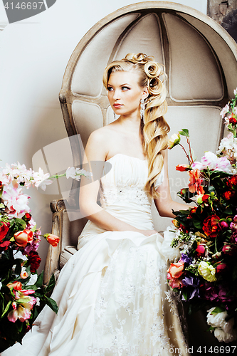 Image of beauty young bride alone in luxury vintage interior with a lot o