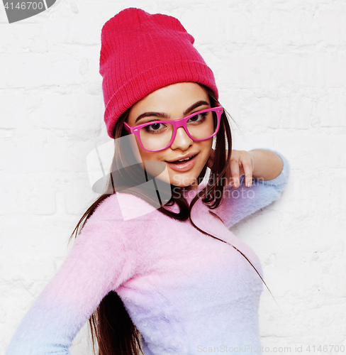 Image of pretty young teenage girl hipster in pink glasses and hat emotional posing happy smiling, lifestyle people concept