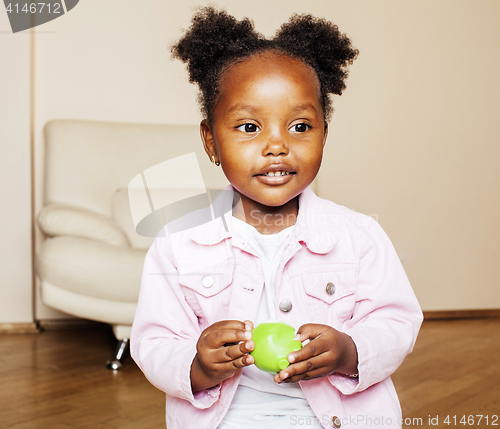 Image of little cute african american girl playing with animal toys at ho