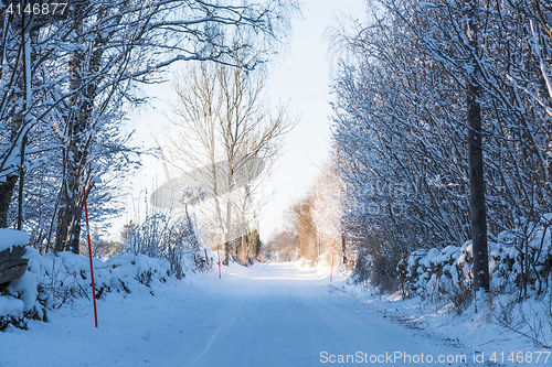 Image of Country road through a snowy winter landscape