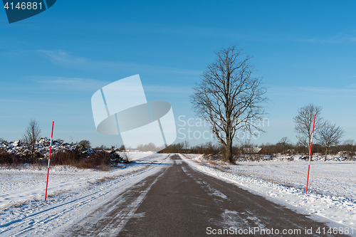 Image of Snowy country road with snow stakes