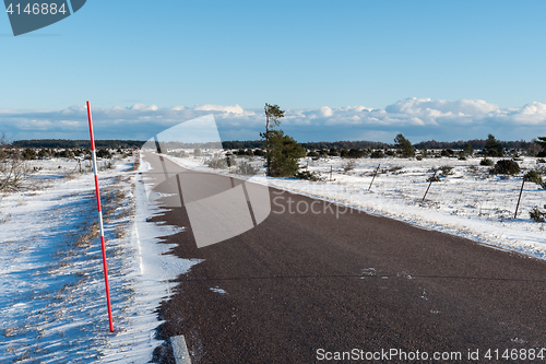 Image of Snow stake by a country road side in a plain landscape