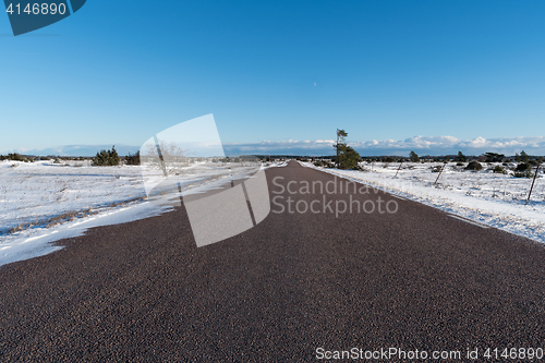 Image of Winter scene from a straight road through a great plain landscap