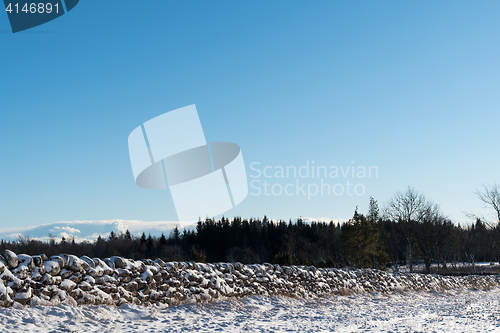 Image of Landscape with snow covered stone wall