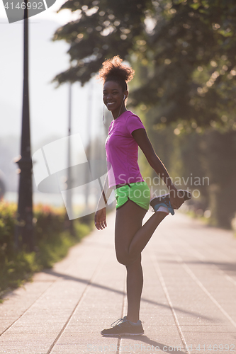 Image of Black woman doing warming up and stretching