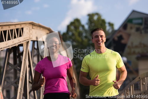 Image of multiethnic couple jogging in the city