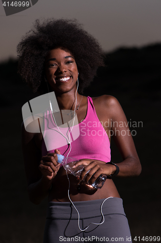 Image of african american woman jogging in nature