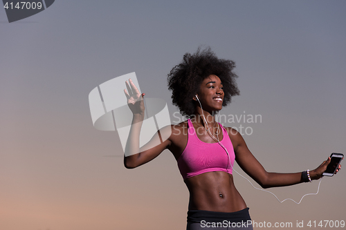 Image of young black girl dances outdoors