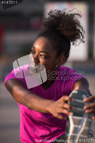 Image of African American woman doing warming up and stretching