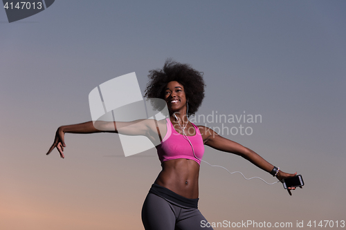 Image of young black girl dances outdoors