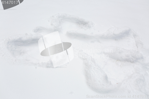 Image of angel silhouette or print on snow surface