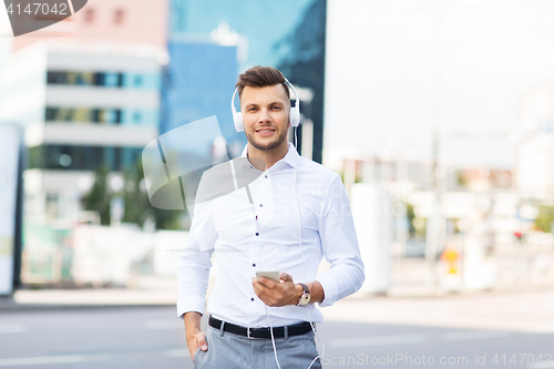 Image of man with headphones and smartphone listening music