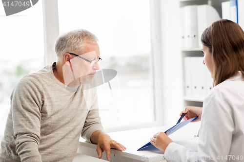 Image of senior man and doctor meeting at hospital